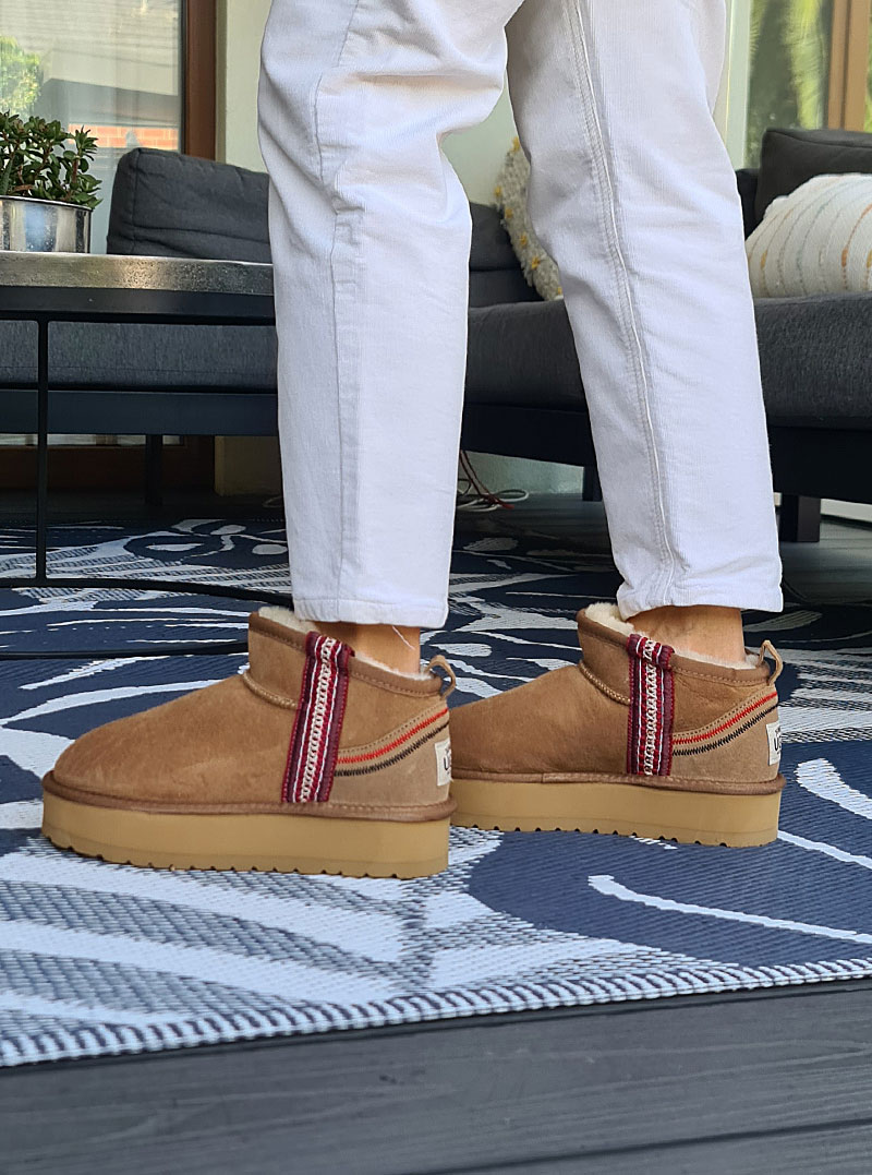 The bohemian-inspired details—colorful stitching on the heel counter and bright knit pattern straps along the sides